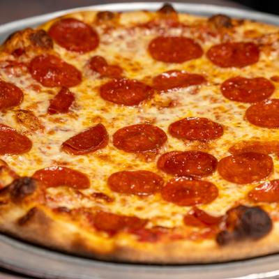 Pepperoni pizza served on a metal tray.