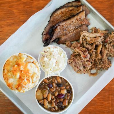 Barbecue platter with brisket, pulled pork, baked beans, coleslaw and mac and cheese.