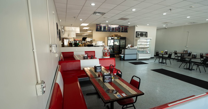 Interior, seating area, bar and open kitchen in the back, checkout counter