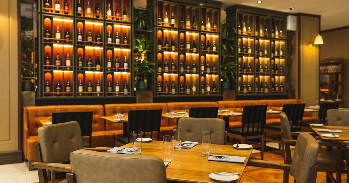 Interior, dining room with wine racks and set tables