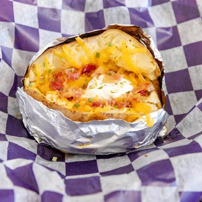 Loaded baked potato filled with various ingredients.