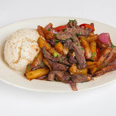 Beef sauteed with onions, tomatoes, cilantro, fried potatoes, and served with rice.