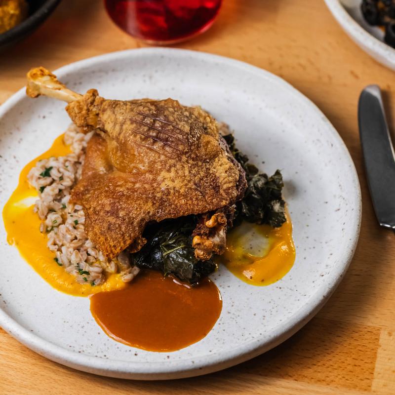 menu item 15 of 22, Confit Duck Leg, Carrot, Smoked Farro, Collard Greens, Sumac