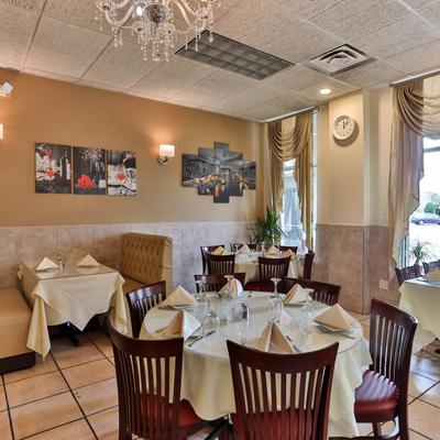 Interior with standard and booth seating, tables ready for guests, and wall art.