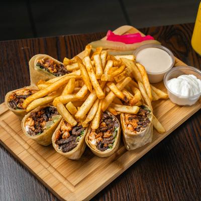 Arabic mix shawarma platter with pickles, fries and sauces.