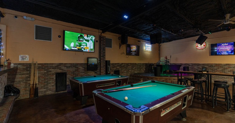 Interior, pool tables, TV on the wall