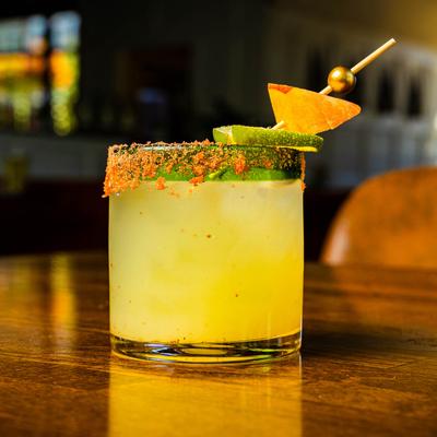 Mango Margarita, with spiced rim, mango and lime garnish.