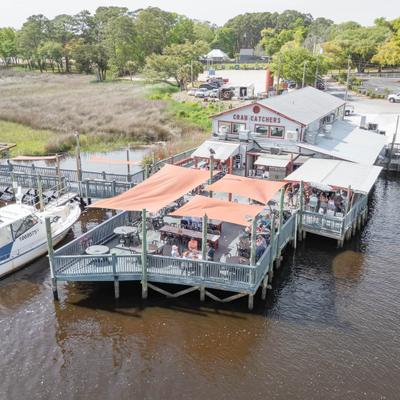 Aerial view of waterfront restaurant with outdoor deck.