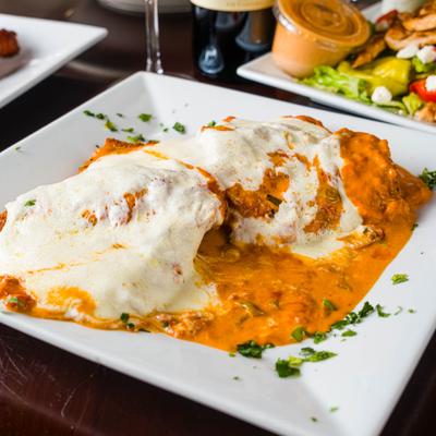 Chicken alla vodka with salad in the background.