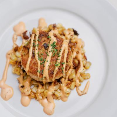 Crab cake topped with roasted red pepper aioli and herbs