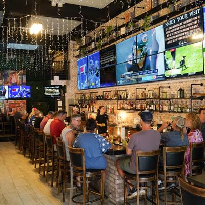 Customers sitting a the bar.