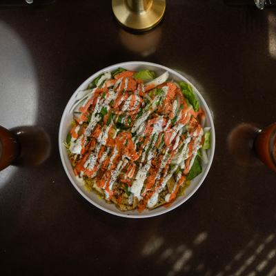 Grilled Chicken Salad covered in sauces.