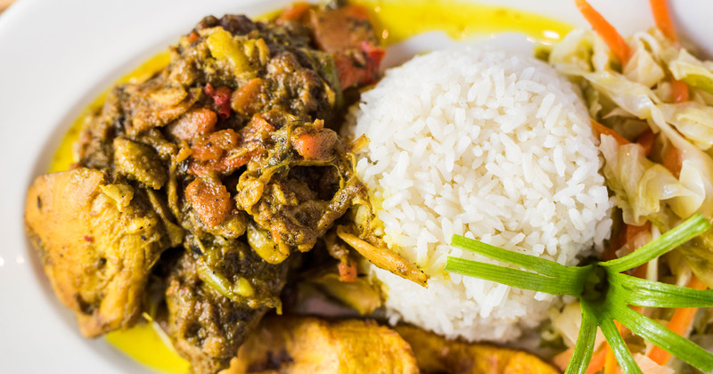Grilled sliced meat with vegetables, rice and salad on the side