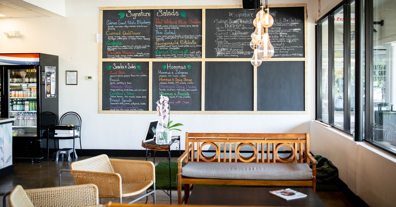 Interior, seating by a window, menu chalkboards on a wall