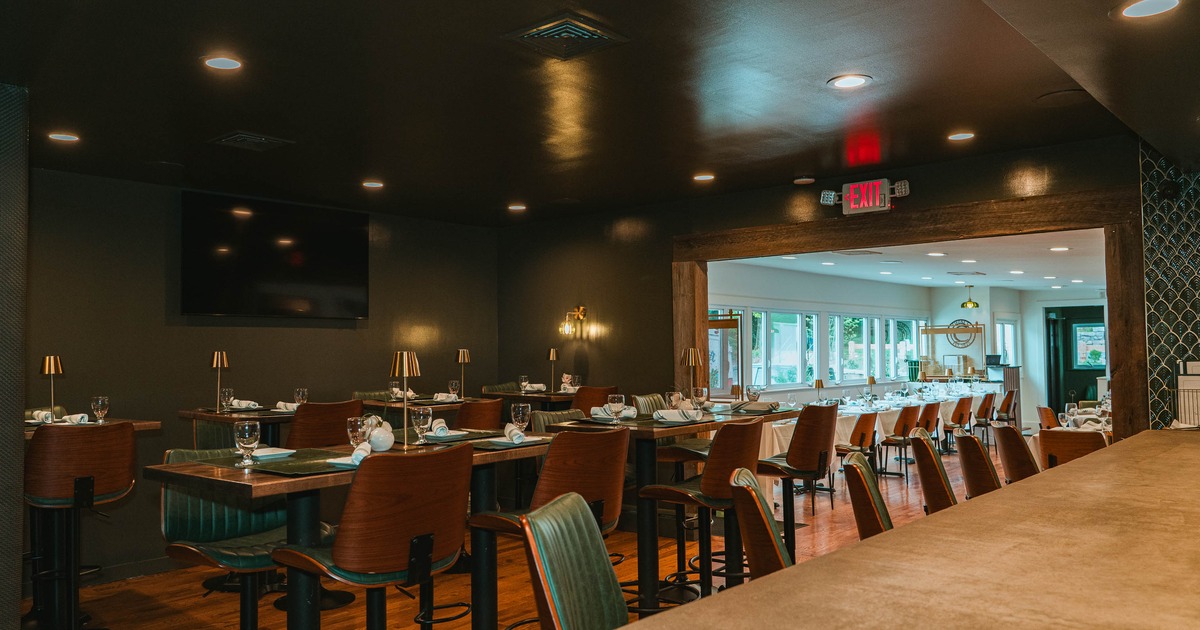 Elegant dining room with set tables and green chairs