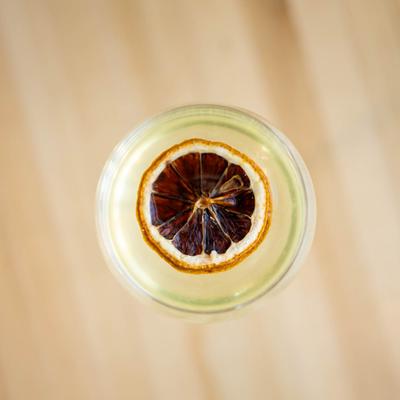 The Orient cocktail decorated with a dry citrus wheel.