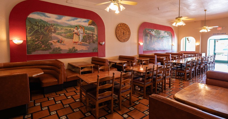 Interior, dining tables, chairs, leather booths, paintings