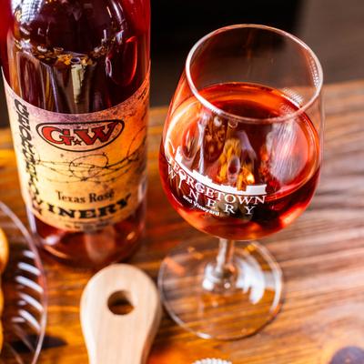 A glass and a bottle of Georgetown Winery Texas Rose.
