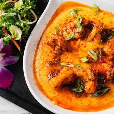 Shrimp and Grits, served with mixed greens.