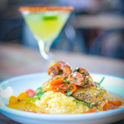 Texas Red Snapper, with a cocktail in a Martini glass in the background.