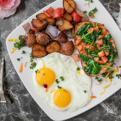 Spinach and tomato bruschetta, served with potatoes and eggs