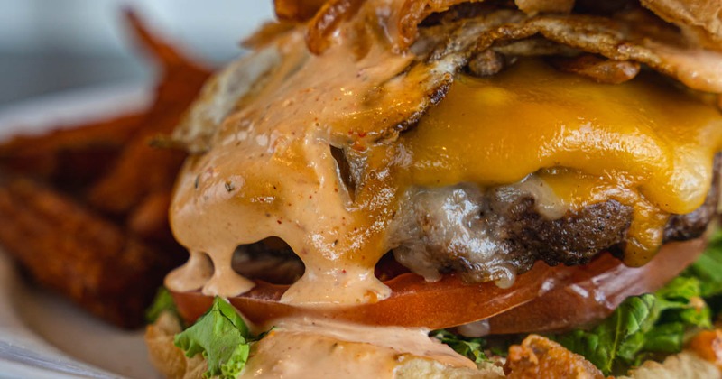 Bacon cheeseburger, with fried egg, lettuce, and tomato