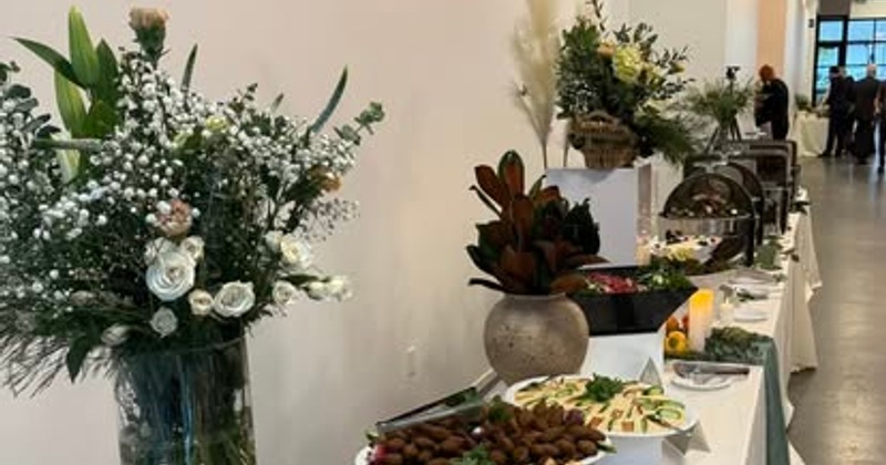 Elegant buffet setup with flowers and Lebanese dishes