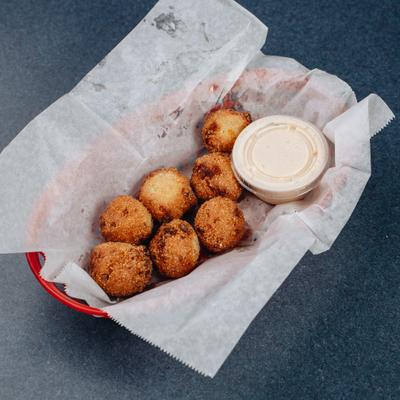 Cod cake bites served with dipping sauce.