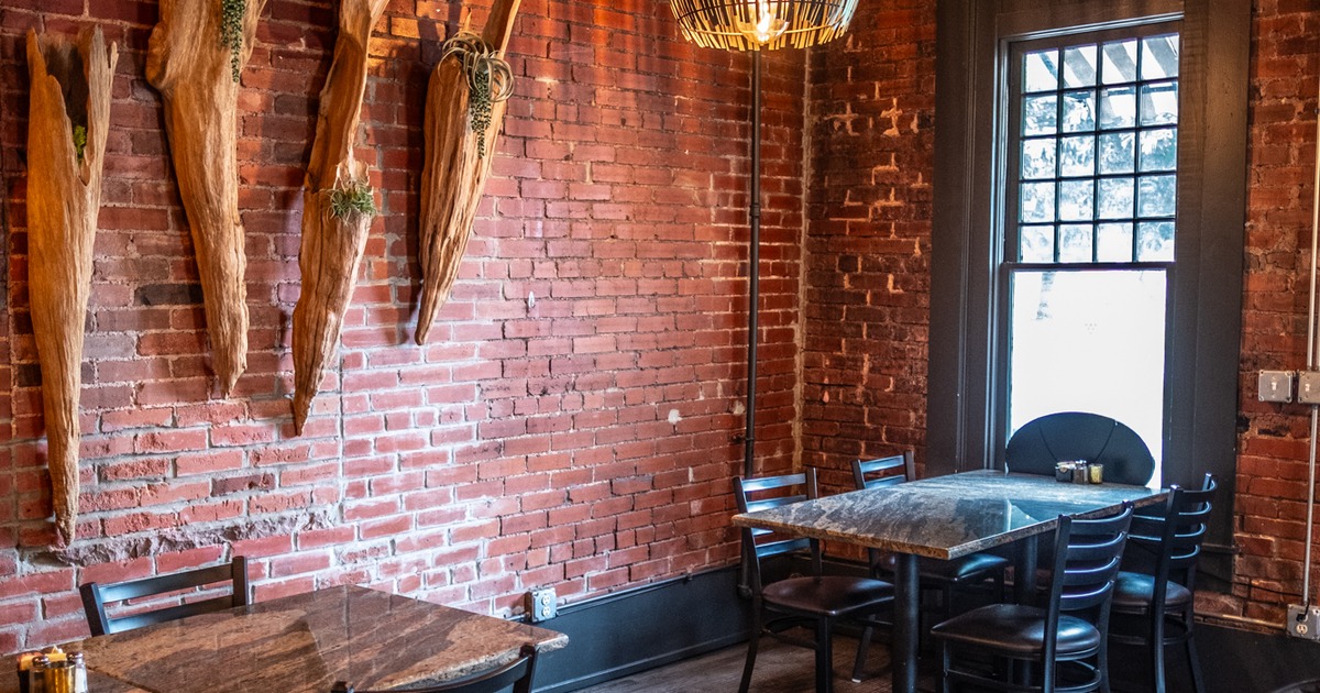 Diner area, intersesting decoration on brick wall, tables, chairs
