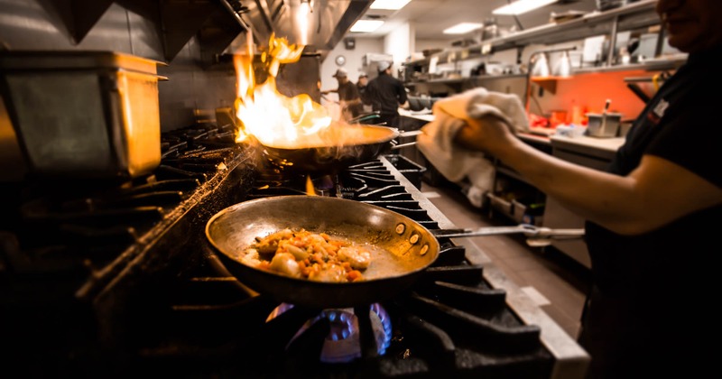 Kitchen, staff cooking food