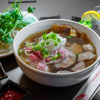 Bowl of beef Pho, served on the table.