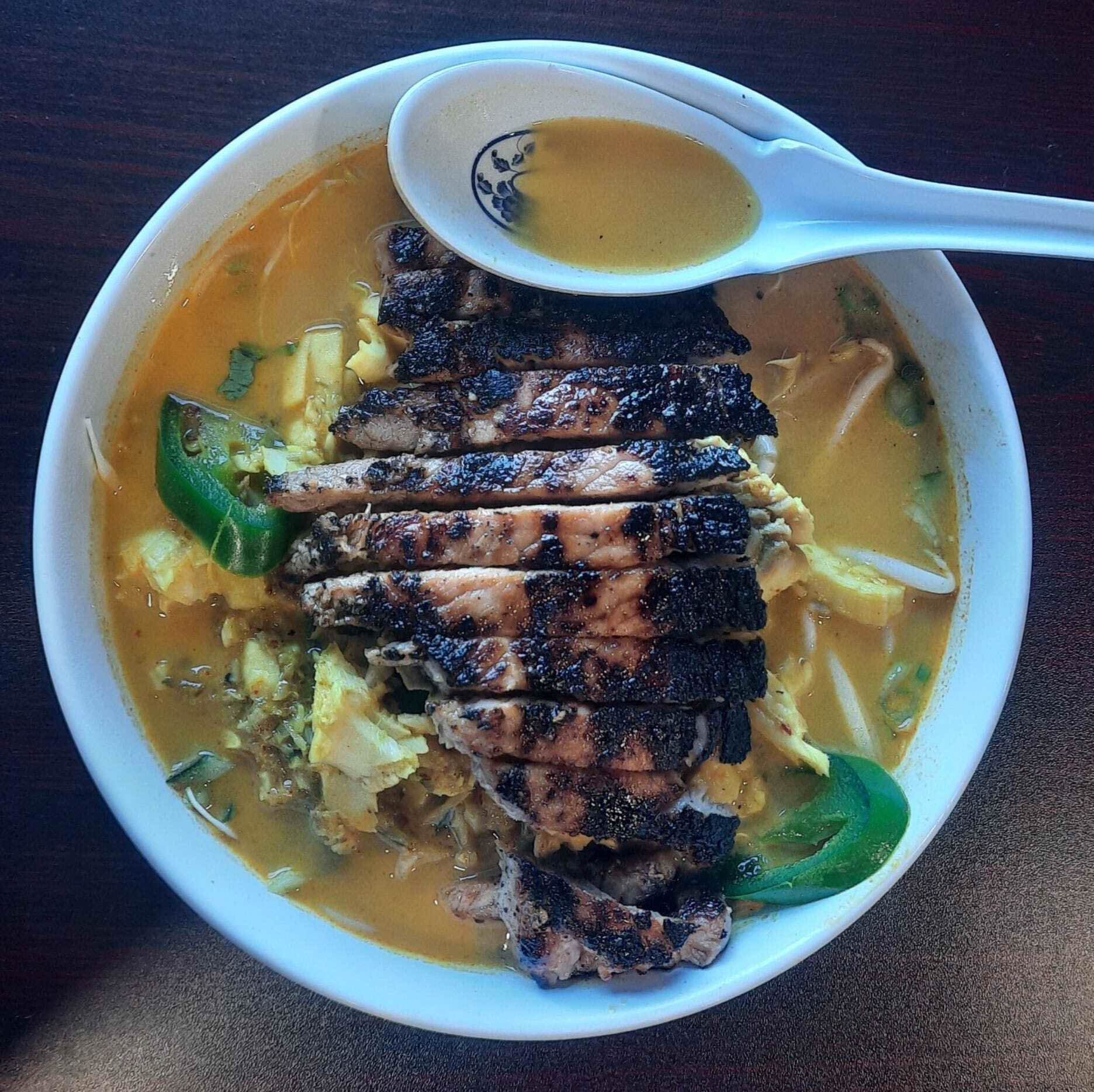 Cambodian-style noodle soup topped with grilled chicken