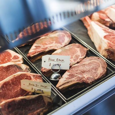 Assorted raw steaks in the display case.