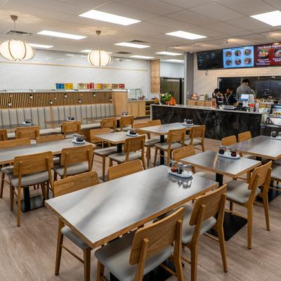 Interior with benches, tables, chairs and ordering counter.