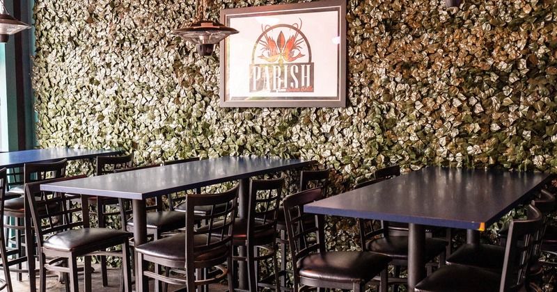 Interior, black long tables for six and chairs ready for guests