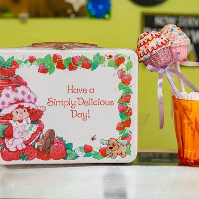 Decorative sign and cupcake display on a counter.