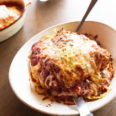 Fried Chicken Parmesean with spaghetti served on the table.