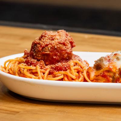 A plate with Spaghetti and meatball, lasagna and chicken Parmesan, close up.