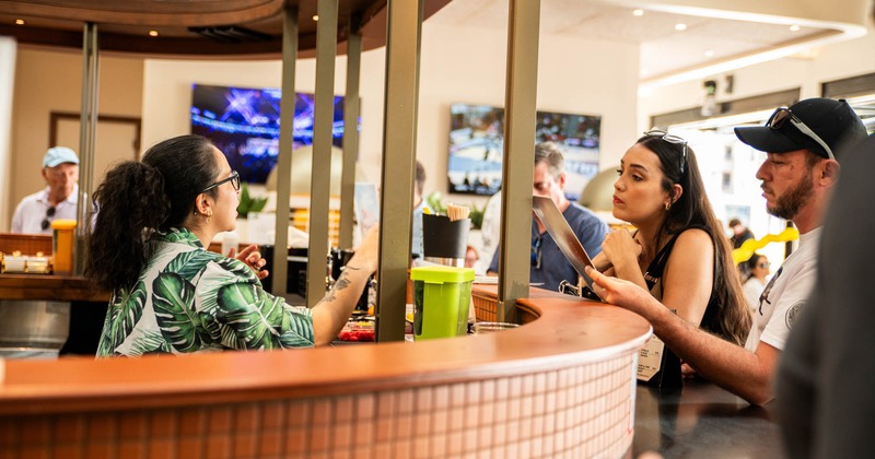 A person ordering at the bar counter