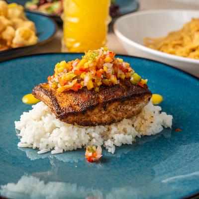 Mahi Mahi with rice, topped with mango salsa.
