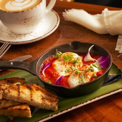 Shakshuka served with sourdough and a cup of latte.