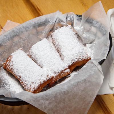 Fried Cheese Cake Bites dusted with powdered sugar.