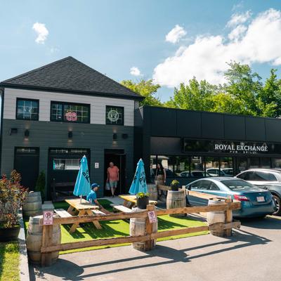 Exterior of The Royal Exchange Pub and Grill with outdoor seating.