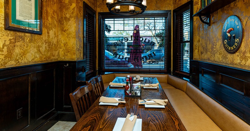 Interior, corner banquette seating, table ready for guests