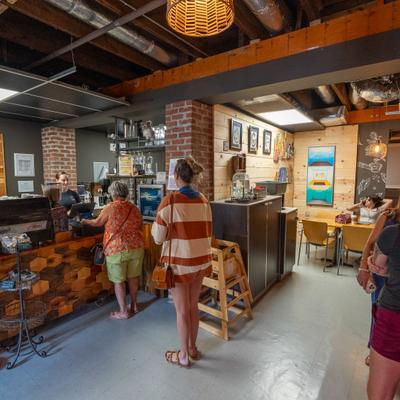 Customers waiting in line at a cozy coffee shop.