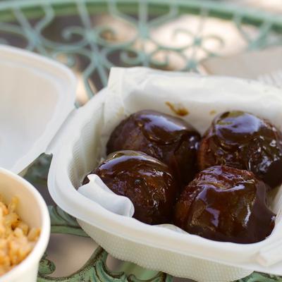 Meatballs wrapped in bacon and smothered in BBQ sauce.