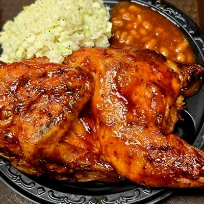 BBQ Chicken plate with baked beans and coleslaw.
