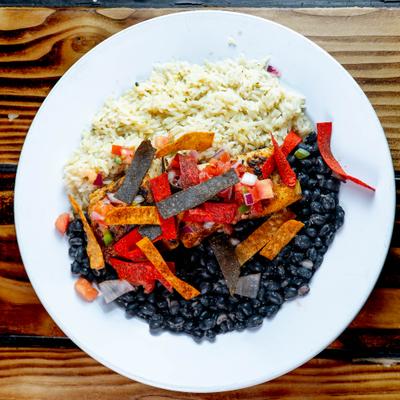 Baja Mahi Mahi served on a bed of cilantro rice, seasoned black beans and tortilla strips.