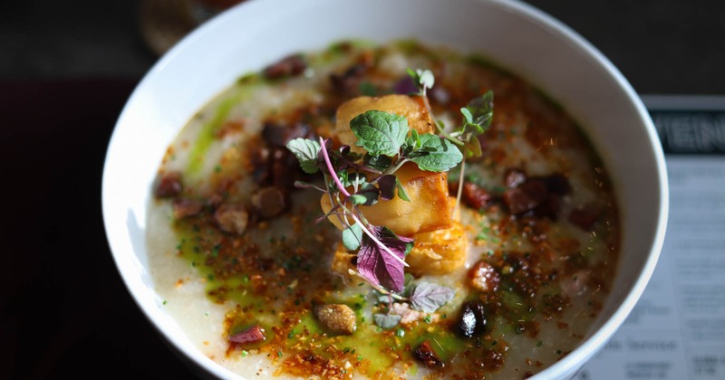Asian rice porridge with pork balls, cilantro chimichurri, and bacon lardons