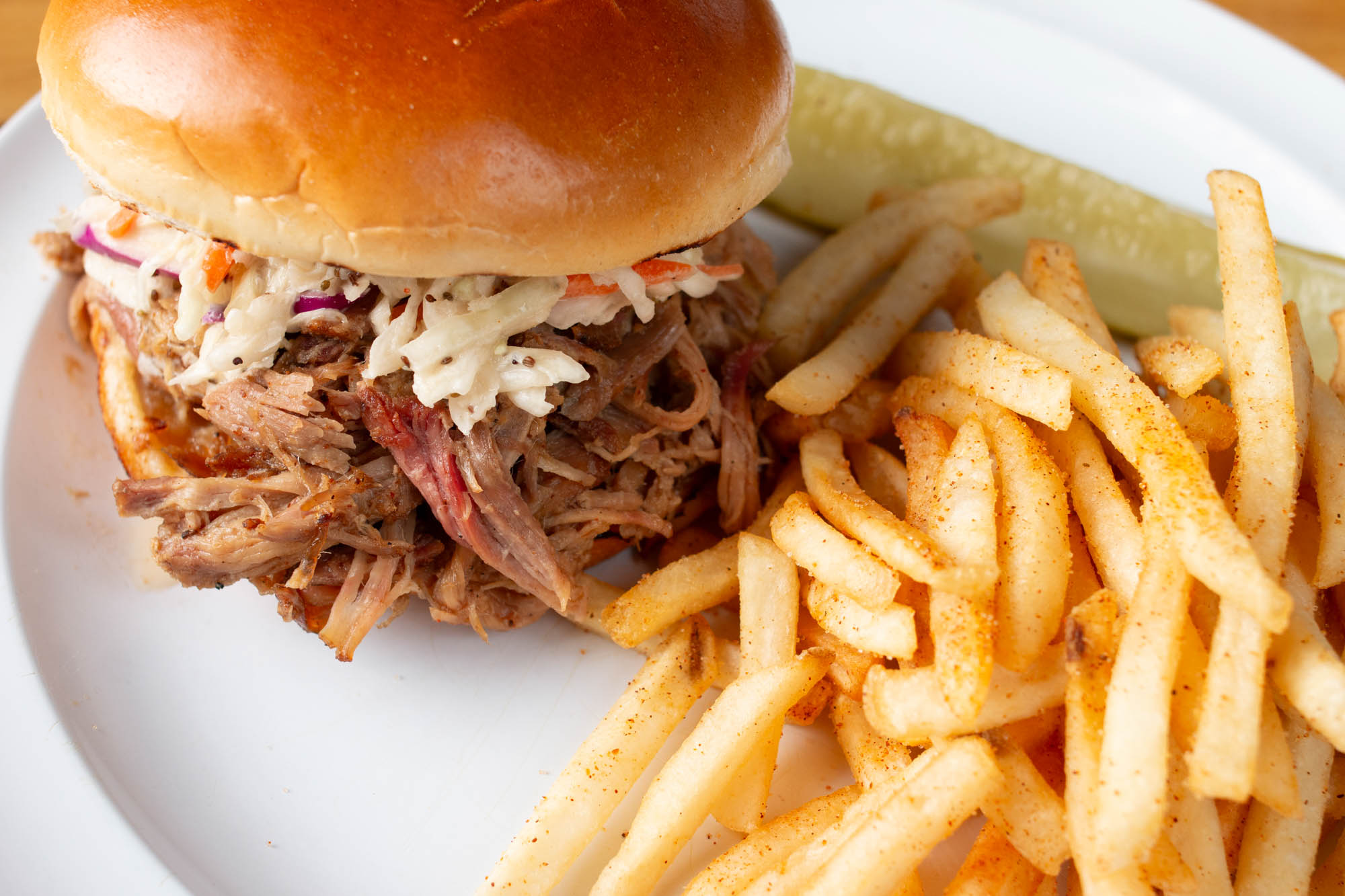 Pulled pork sandwich with coleslaw, served with fries